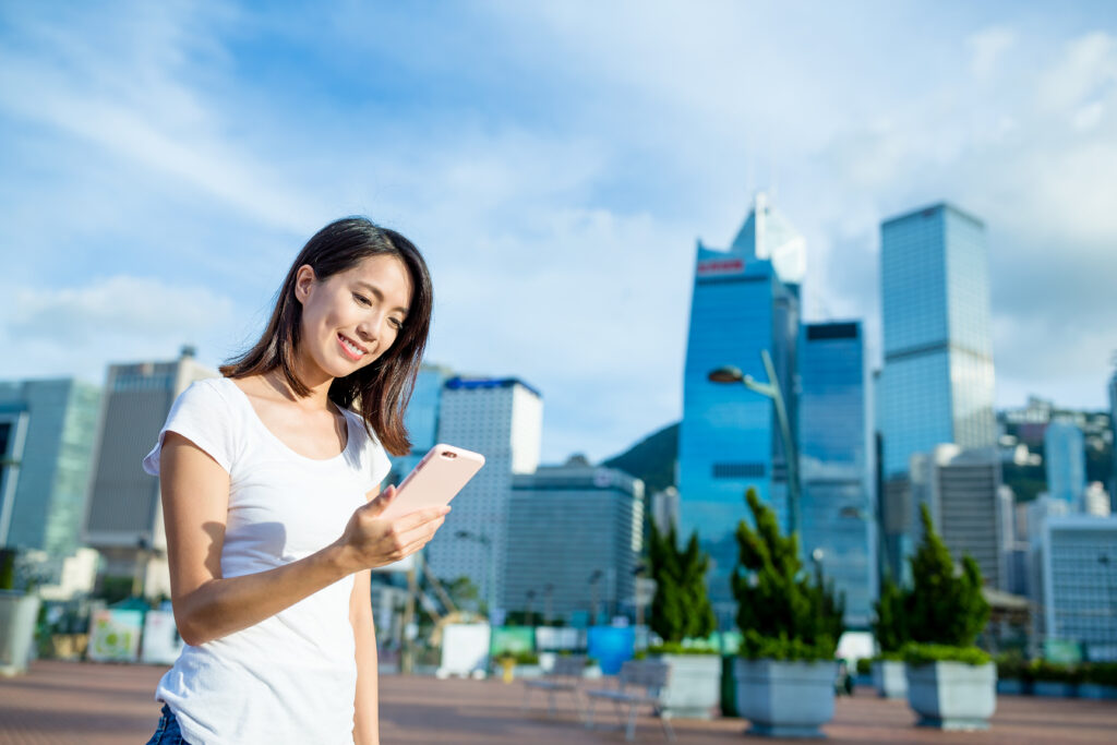 consumer behavior in online shopping: Woman using mobile phone at outdoor